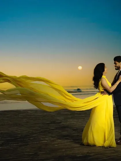A perfect sunset moment on the beach. Our yellow flying gown catches the light and wind beautifully, creating a magical effect. Paired with a smart casual suit for him, this is an ideal rental choice for a beach pre-wedding photoshoot.