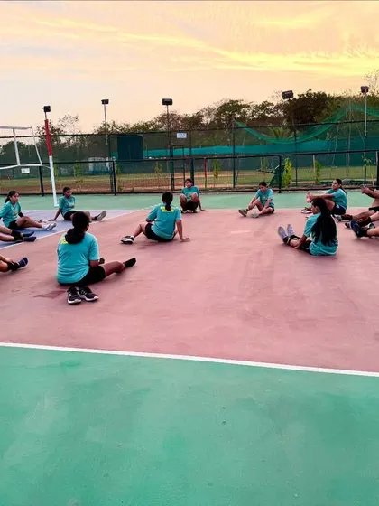 Post-practice recovery is essential. Our girls' team stretching on the court after a tough training session for the Shanghai tournament.