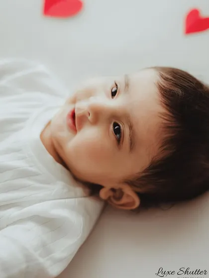 A close-up portrait of a happy five-month-old baby, capturing his sweet smile and bright eyes.