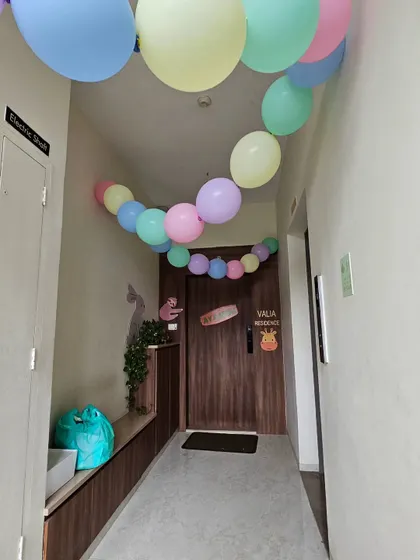 A simple yet festive way to welcome guests. A colorful pastel balloon garland leads the way to the front door of the party residence.