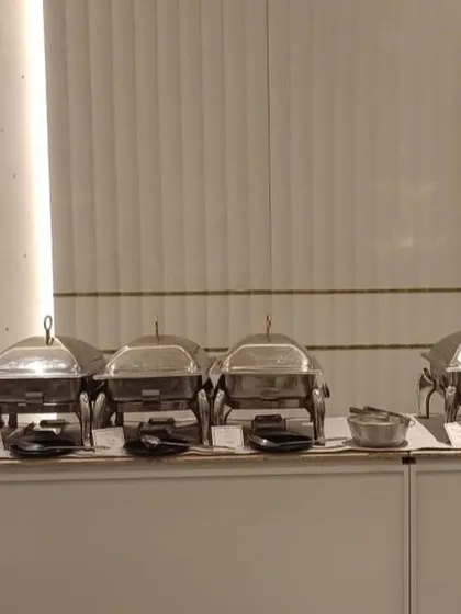 A clean and minimalist buffet setup that blends perfectly with the modern interiors of the party venue.
