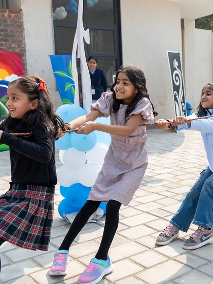 Teamwork makes the dream work! A game of tug-of-war brings out the competitive spirit and lots of smiles during a fun-filled birthday celebration.