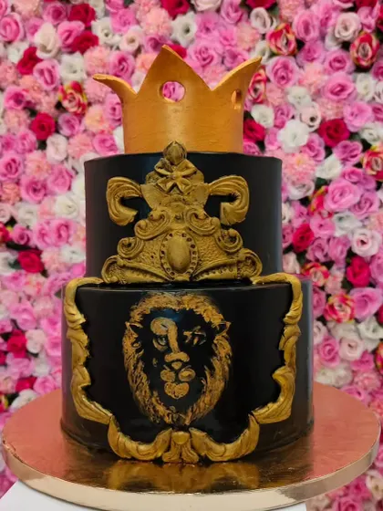 A majestic 3kg 'King Cake' in a rich chocolate mousse flavor. The black and gold design, featuring a lion and a crown, is bold and regal.