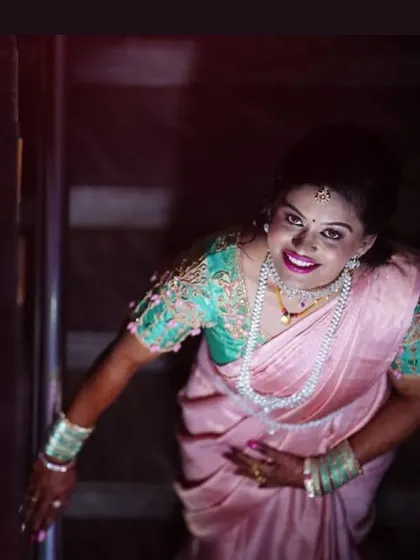 A dramatic, top-down view of the reception look, emphasizing the bright smile and glowing makeup.