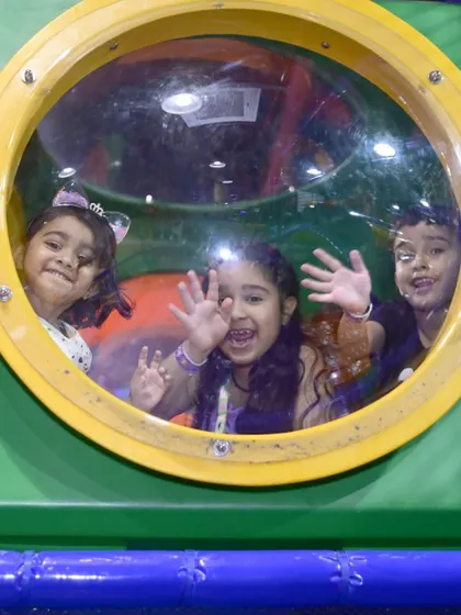 Waving hello from inside one of the tunnel portholes. Our play structure is full of fun nooks and windows for kids to peek out from.