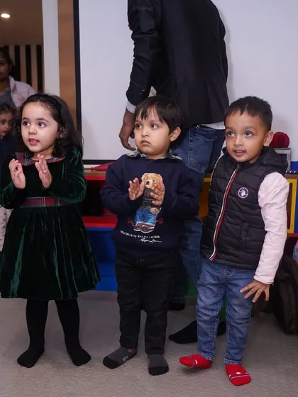 Young children watching the party entertainment with excitement.