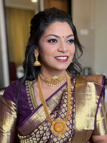 The bride looks radiant and happy, ready for her traditional ceremony.