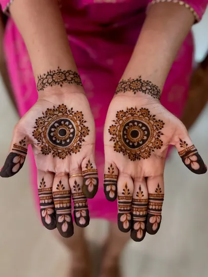 A minimal yet elegant mandala design for the bride's sister, coordinating with the bride's minimal wedding mehendi.