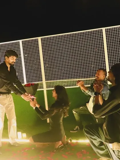 The climax of a surprise flashmob proposal. The team kneels alongside the bride-to-be as she proposes, creating a powerful and supportive backdrop for this life-changing question.