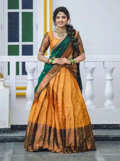 A classic full-length pose in the mustard and green half-saree, showcasing its timeless elegance.