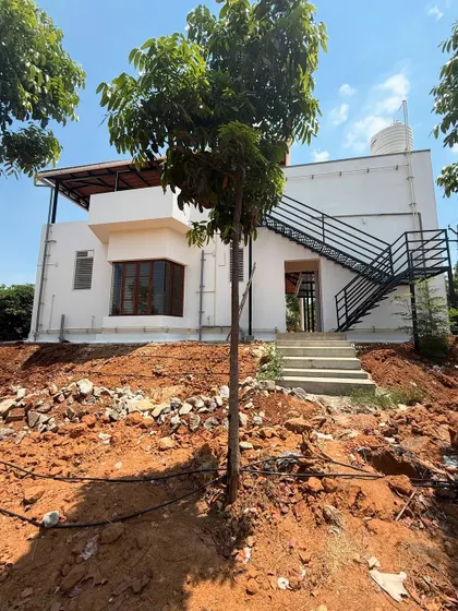 A look at the rear of the property, showing the external staircase that provides access to the upper floor. This is a practical design choice that also adds a modern, industrial touch to the home's exterior.