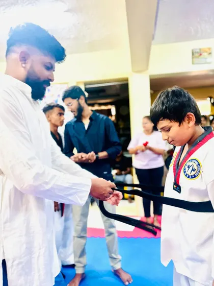 This young boy has earned his black belt.