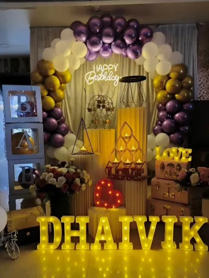 Another view of our popular purple and gold birthday package for 'Dhaivik', showcasing the full arrangement with 'BABY' blocks and decorative props.