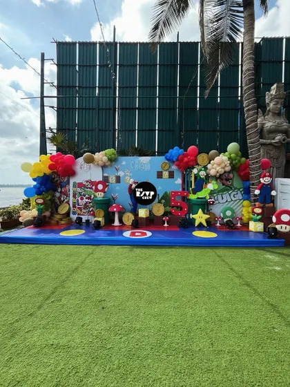 It's-a-me, Mario! I brought the entire Super Mario World to life for this 5th birthday, featuring a massive themed stage with characters, question blocks, coins, and colorful balloons, all set against a beautiful outdoor backdrop.
