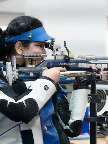 A female rifle shooter takes aim, her form perfected through countless hours of practice at our academy. The focus is on consistency and precision.
