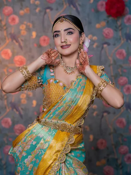 The model posing playfully, showing the intricate details of the blouse and the vibrant colors of the saree.