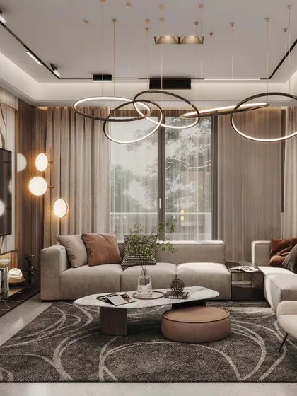 This design showcases a sleek chandelier, rich drapes, and a plush rug. The open-plan layout connects to a large balcony, blurring the lines between indoors and outdoors.