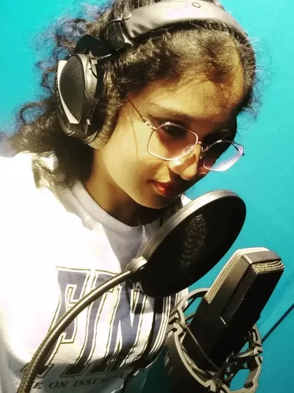 A candid shot from a studio session. This is me completely in the zone, focused on the details of the vocal track and making sure every note carries the right emotion for the song.