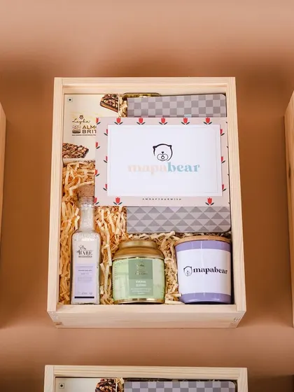 The contents of the Mapa Bear PR boxes, including custom-branded candles and bath products, were carefully selected to create a celebratory and relaxing experience.