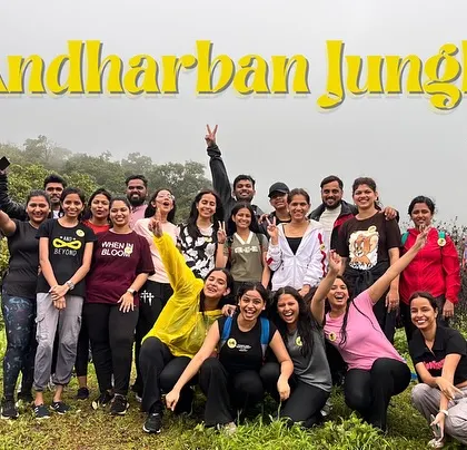A cheerful group photo from the Andharban Jungle Trek, also known as the 'Dark Forest'. It's a unique monsoon trek that takes you through a dense jungle.