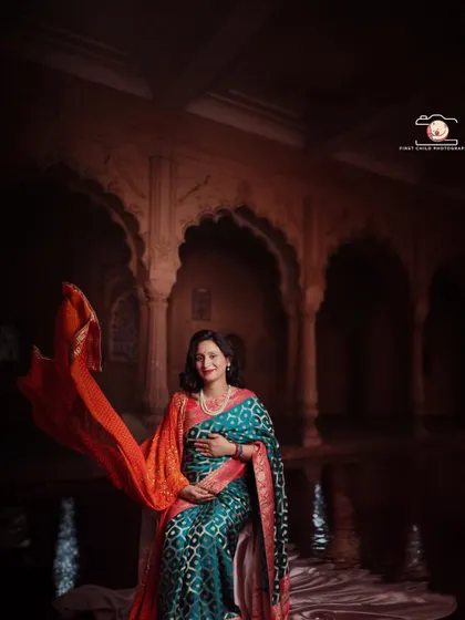 This portrait captures the divine elegance of motherhood. I used dramatic lighting in my studio to highlight the rich textures of this beautiful saree and the ornate backdrop, creating a timeless image that feels like a classic painting.