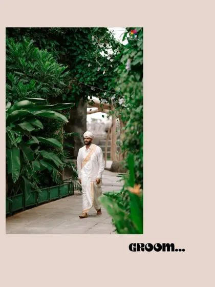 A candid shot of the groom walking through a lush green pathway. This photo captures a natural, relaxed moment during the wedding day.