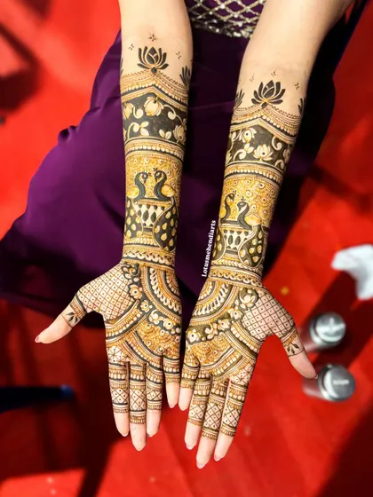 The front view of Rajalakshmi's peacock and lotus themed bridal mehendi. The design is rich with traditional elements, creating a truly royal look.