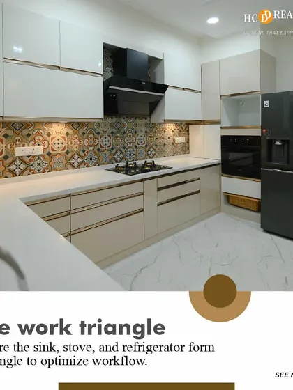 This kitchen design emphasizes the importance of the work triangle, ensuring the sink, stove, and refrigerator are placed for optimal workflow. The beige cabinets and patterned tiles create a warm and inviting look.