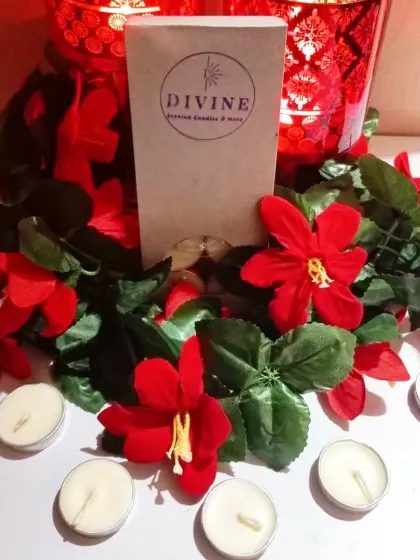 A full view of the unscented tealight pack, with a few candles arranged in front to show the product outside the box.