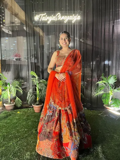 Here I am wearing a popular Aisha Rao lehenga. This shows clients that I am familiar with current designer trends and can source these high-fashion pieces for them.