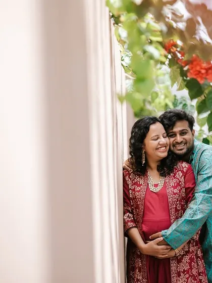 A quiet moment of connection for this expecting couple. We used the soft morning light and vibrant bougainvillea to frame their embrace during this outdoor maternity photoshoot.