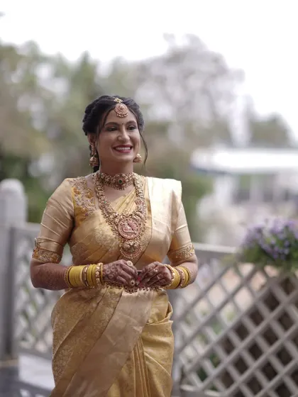 This is one of my beautiful clients, glowing on her special day. The layered antique gold temple jewellery, including a choker and a long haram with a goddess pendant, creates a truly divine look for her muhurtham.