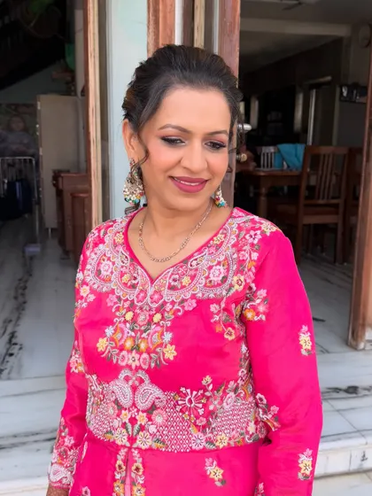 This client is glowing in her bright pink outfit. I used a soft brown smokey eye and a matching pink lip to create a balanced and festive look.