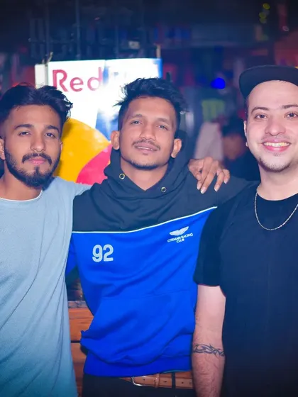 Friends enjoying the music under the club lights. The right track at the right time can make the whole night.