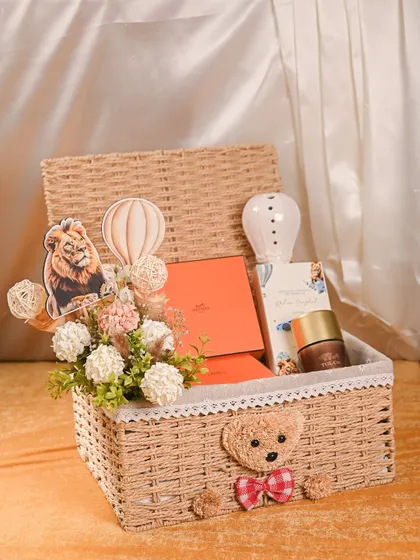 Welcoming a new baby is a precious moment, and I love creating hampers to match. This custom baby announcement basket includes a cute teddy bear, themed decor, and luxury brand gifts, all presented in a beautiful keepsake wicker basket.