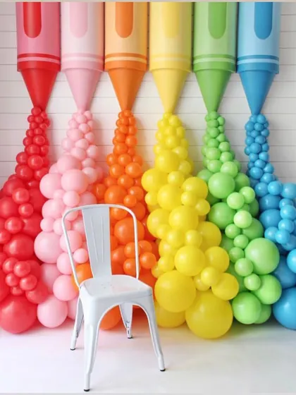 A colorful and creative photo backdrop made of giant crayons with balloon "paint" pouring out. This is a perfect interactive spot for guests at an art-themed party or a back-to-school event.
