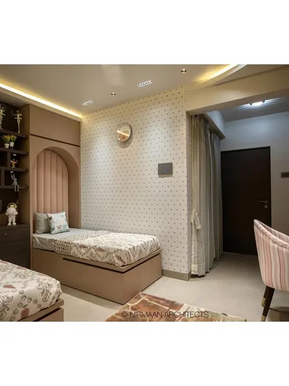 This shared bedroom for two daughters in our Duplex Project features custom beds with upholstered headboards set in arched nooks. The design creates a sense of personal space for each child.
