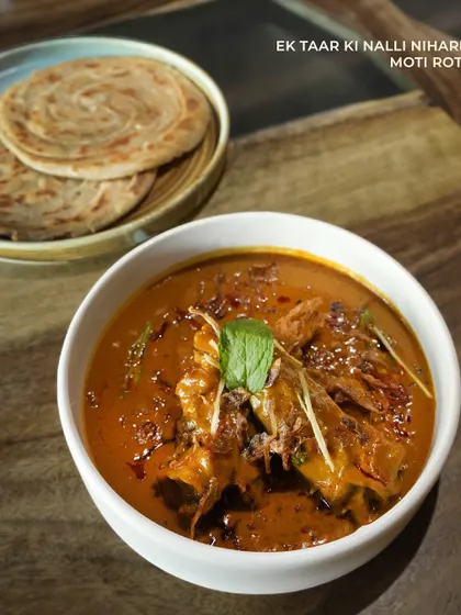 Ek Taar Ki Nalli Nihari, a slow-cooked lamb shank curry that's rich and gelatinous, served with a flaky Moti Roti. A true indulgence.