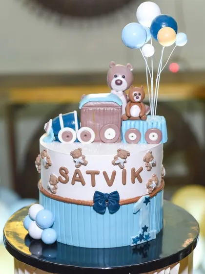 A charming teddy bear and train cake. The details on these custom cakes are incredible, and we make sure to get a perfect shot.