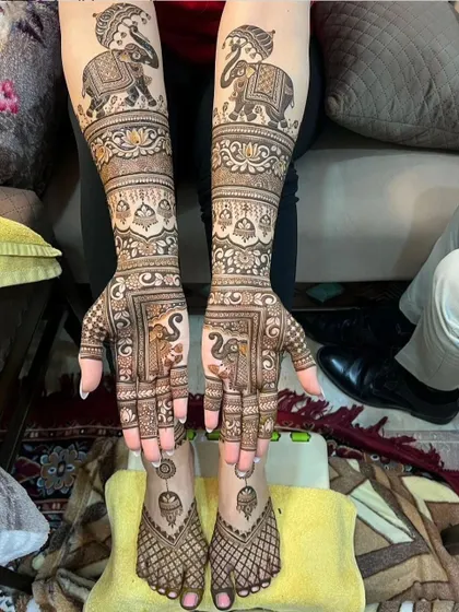 This full-body design features majestic elephants on the arms and feet, creating a symmetrical and regal look. The net-like pattern on the feet is a classic choice.