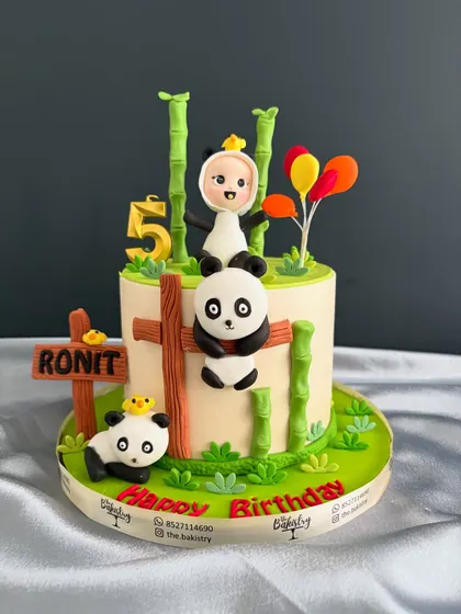 A full view of the adorable panda-themed birthday cake for Ronit.