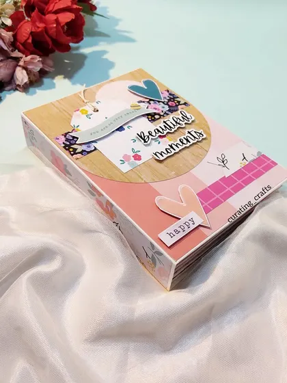 A compact scrapbook for a bride-to-be, with "beautiful moments" on the cover.