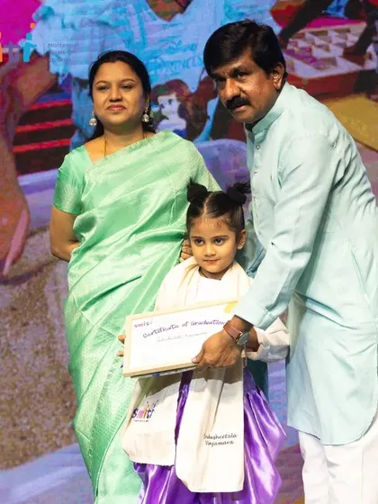 A young graduate is congratulated on stage. We celebrate every child's unique journey and growth.