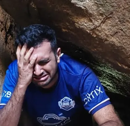 The struggle is real but fun! A trekker squeezing through a tight spot in the Anthargange caves.
