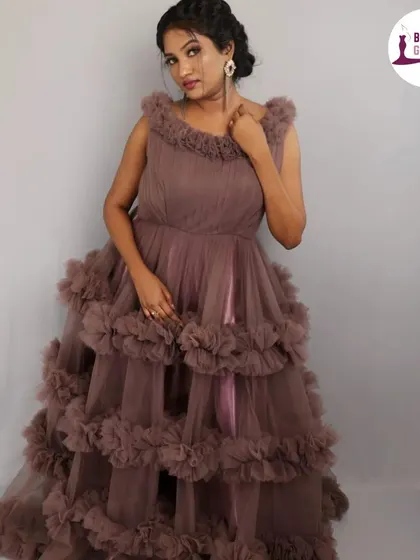 A full-length studio shot of our tiered ruffle gown in a sophisticated dusty purple shade. This view shows the complete silhouette and how it falls.