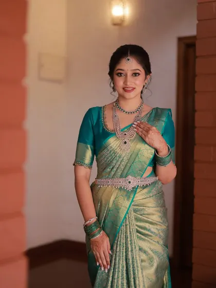 This bride looks effortlessly elegant. The makeup is polished and refined, and her hair is styled in a soft updo, making for a very graceful bridal appearance.