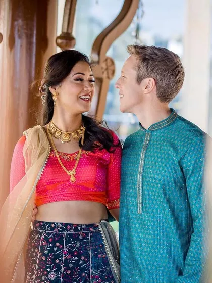 A candid, through-the-frame shot of the couple sharing a look. This composition adds a layer of intimacy and storytelling to the portrait.
