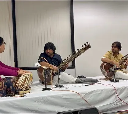 A close-up of our performance in Chicago, showing the concentration and coordination required for a sitar duet. Every concert is a unique musical journey.