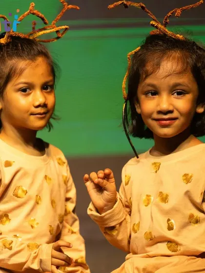 Two girls dressed as deer, their costumes and poses full of character and charm.