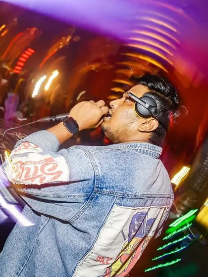 A creative shot with a slow shutter speed, capturing the motion and energy of me on the mic. The blur of lights shows the dynamic club environment.